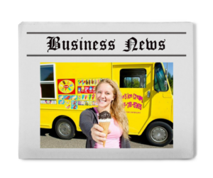 A mock newspaper, with the words 'Business News' written at the top. Underneath the text, is a teenage girl with blonde hair and a pink shirt, holding an ice cream cone, in front of a yellow ice cream truck.