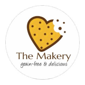 Round personalized label from CardsDirect.com with a cookie in the shape of a heart and a bite taken out of the corner, along with the words 'The Makery, grain-free and delicious' written underneath.
