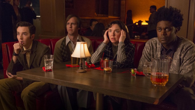 Group of people sitting at a table in a bar.