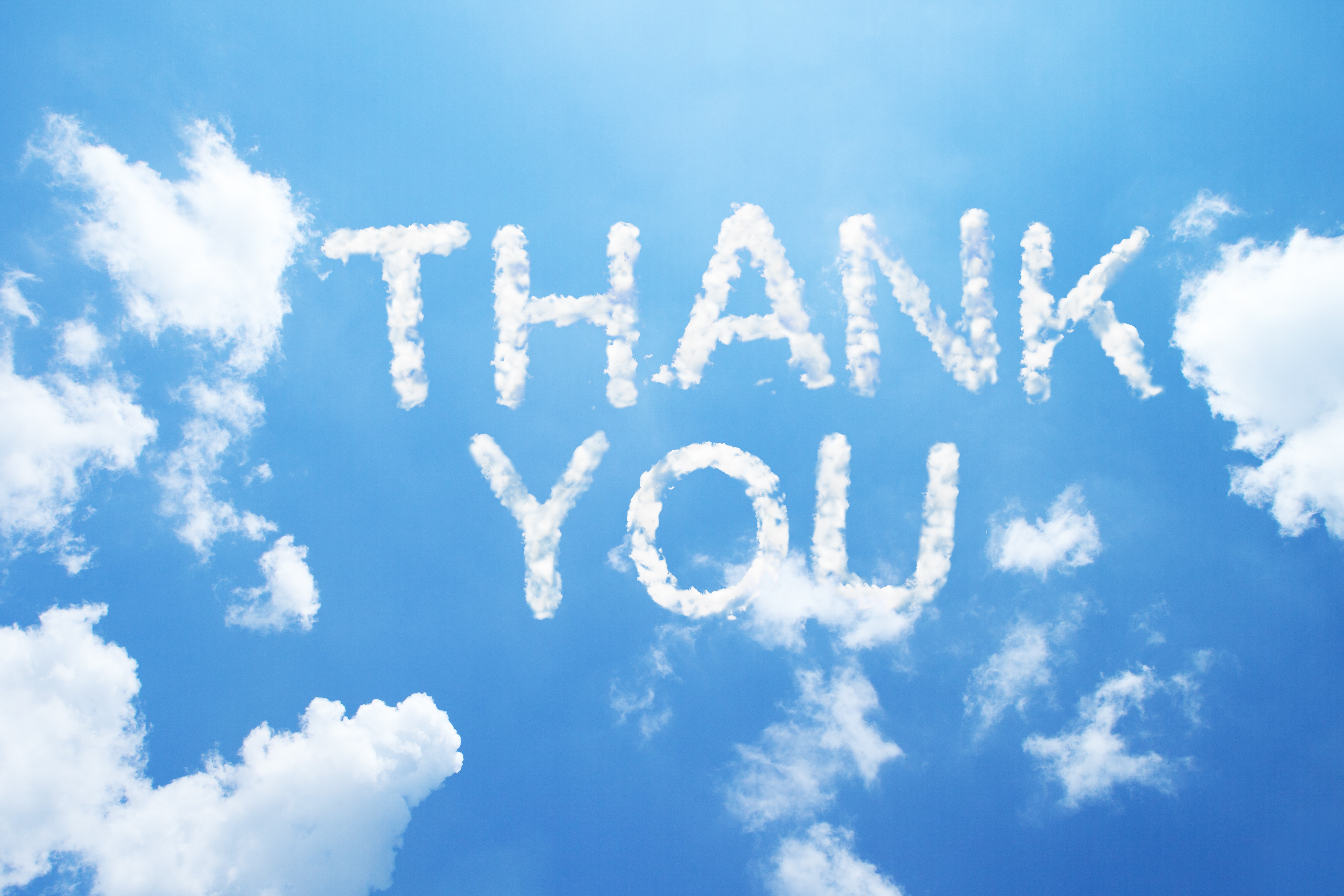 Thank you is written out in a blue sky.