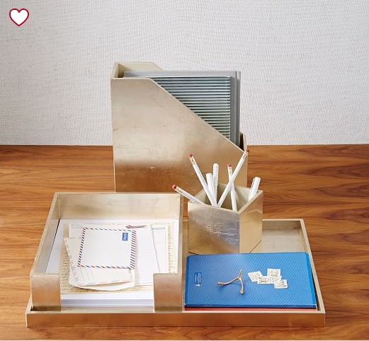 Gold desk organizers holding pens, folders, mail, and other miscellaneous office products.