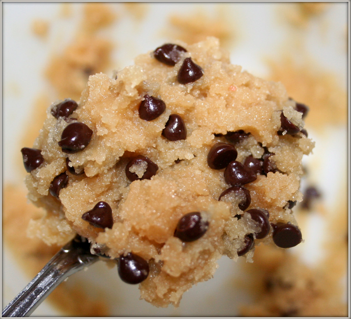 Close-up of a scrumptious gob of chocolate chip cookie dough on a silver spoon.