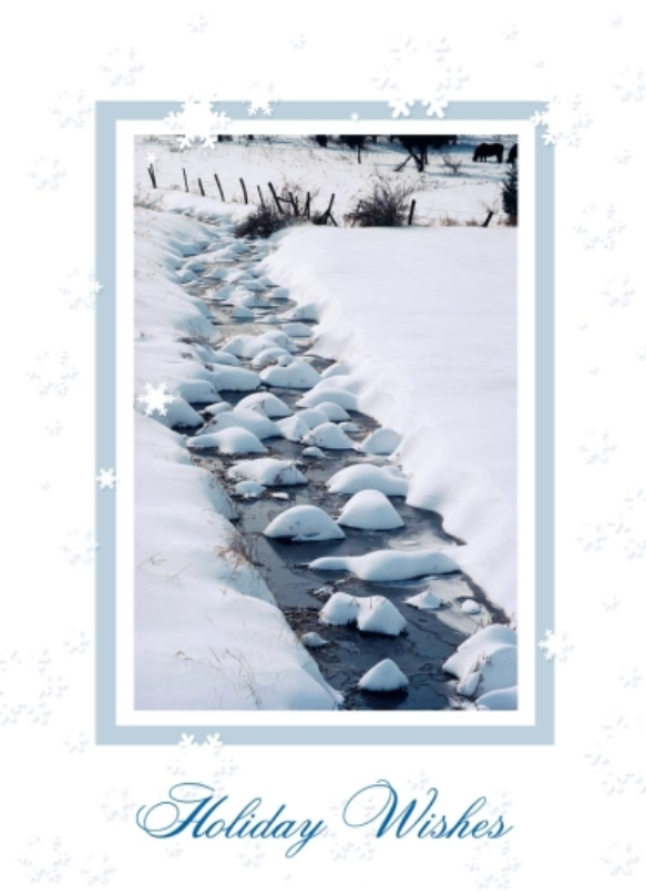 Framed by an icy blue border, this holiday greeting card features a photograph of a winter stream surrounded by snow. Light blue snowflakes fill the front of the holiday card template, dotting the stream and borders. ‘Holiday Wishes’ is shown in a matching blue script. 