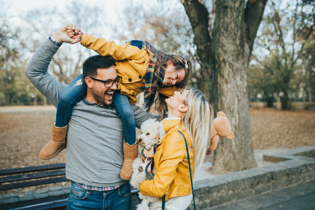 Happy family enjoying together in park.