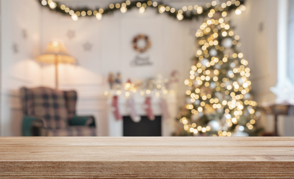 Empty wooden table over defocused christmas background with copy space