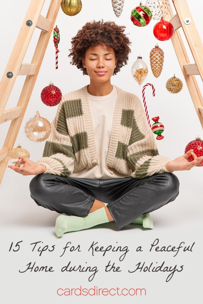 Young black woman sitting under a  wooden ladder strung with Christmas ornaments meditating above a message that reads 15 Tips for Keeping a Peaceful Home During the Holidays in a black script.