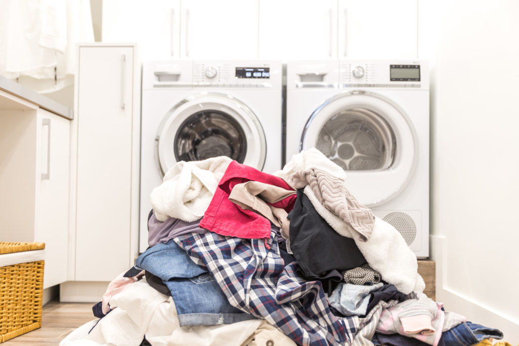 Laundry room with a pile of dirty clothes on floor