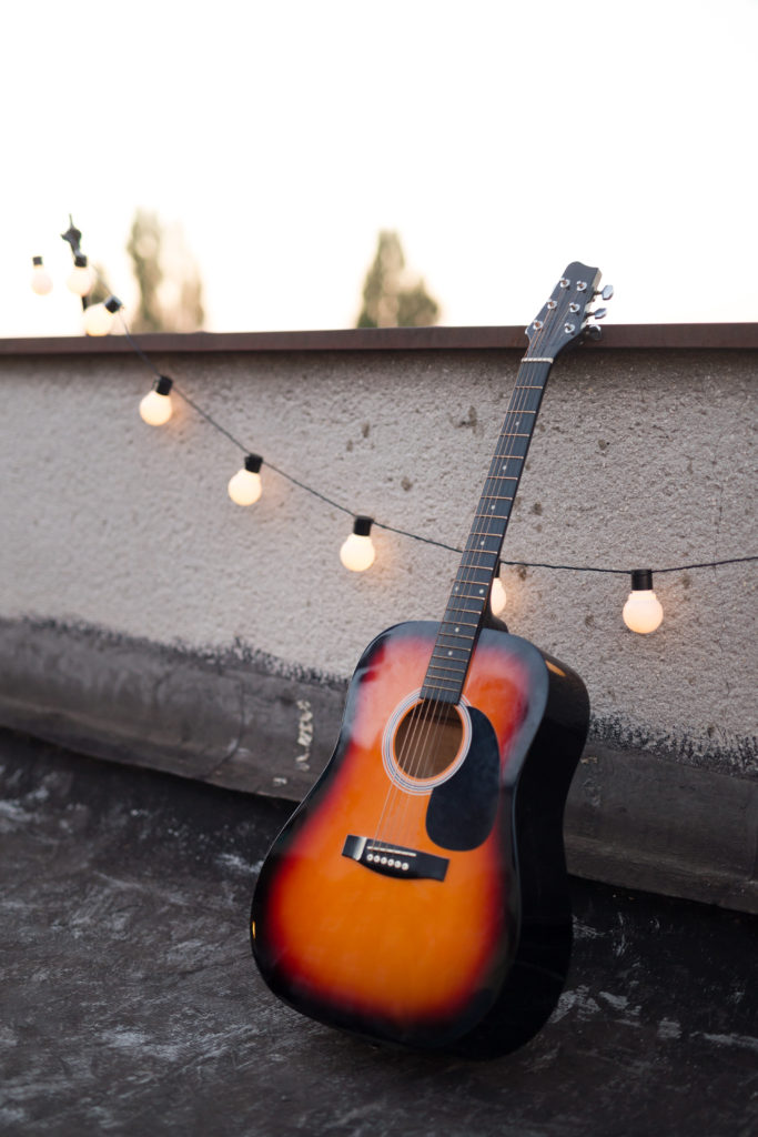 Picture of nice stringed acoustic guitar on rooftop