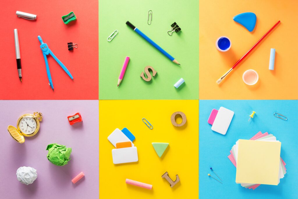 Office and school supplies at abstract colorful background texture