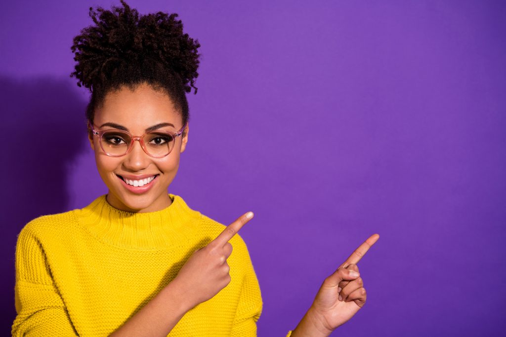 Close-up portrait of her she nice attractive cheerful cheery content wavy-haired, girl showing way direction copy space ad advert isolated over bright vivid shine violet background