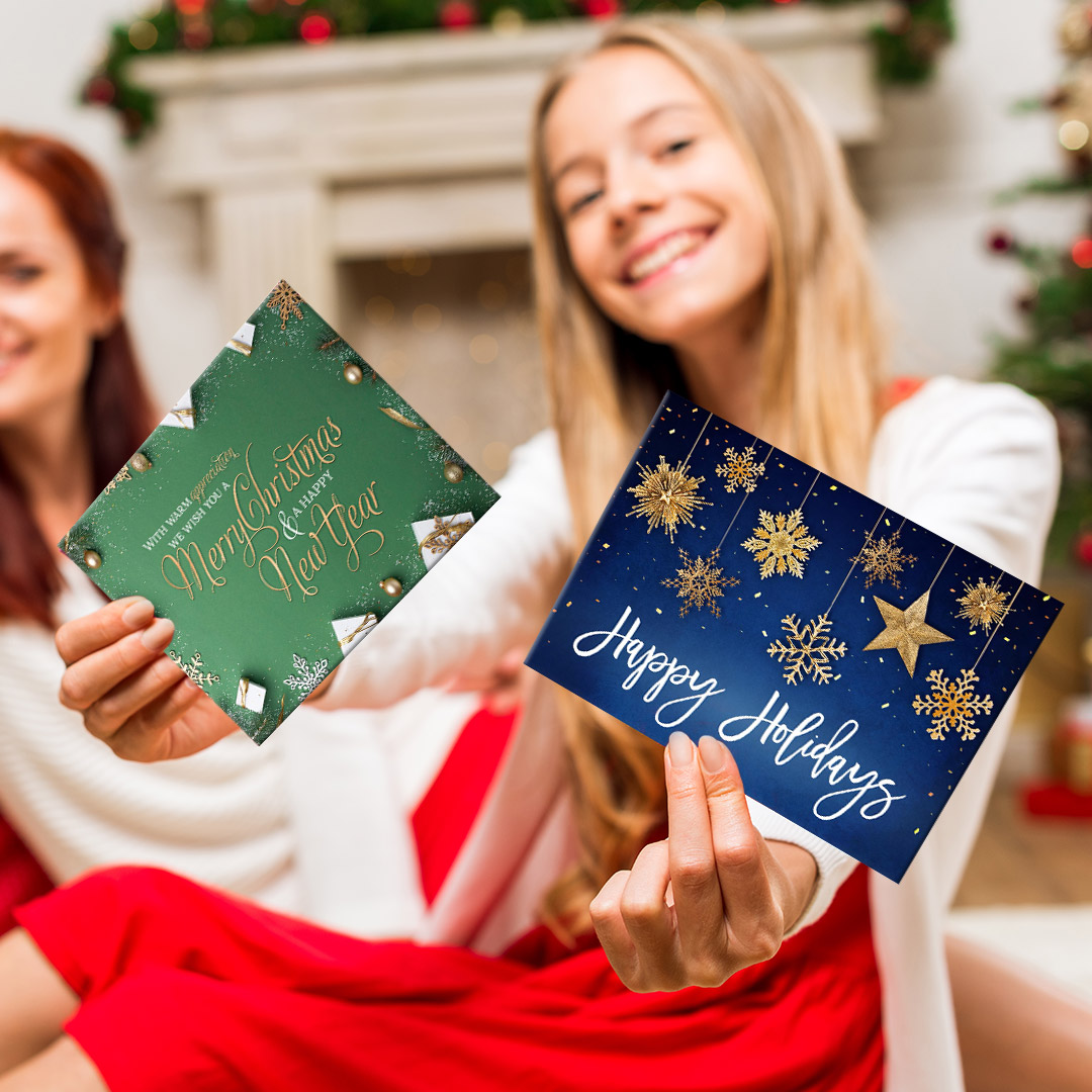 Young woman taking holiday cards out of a big red bag.