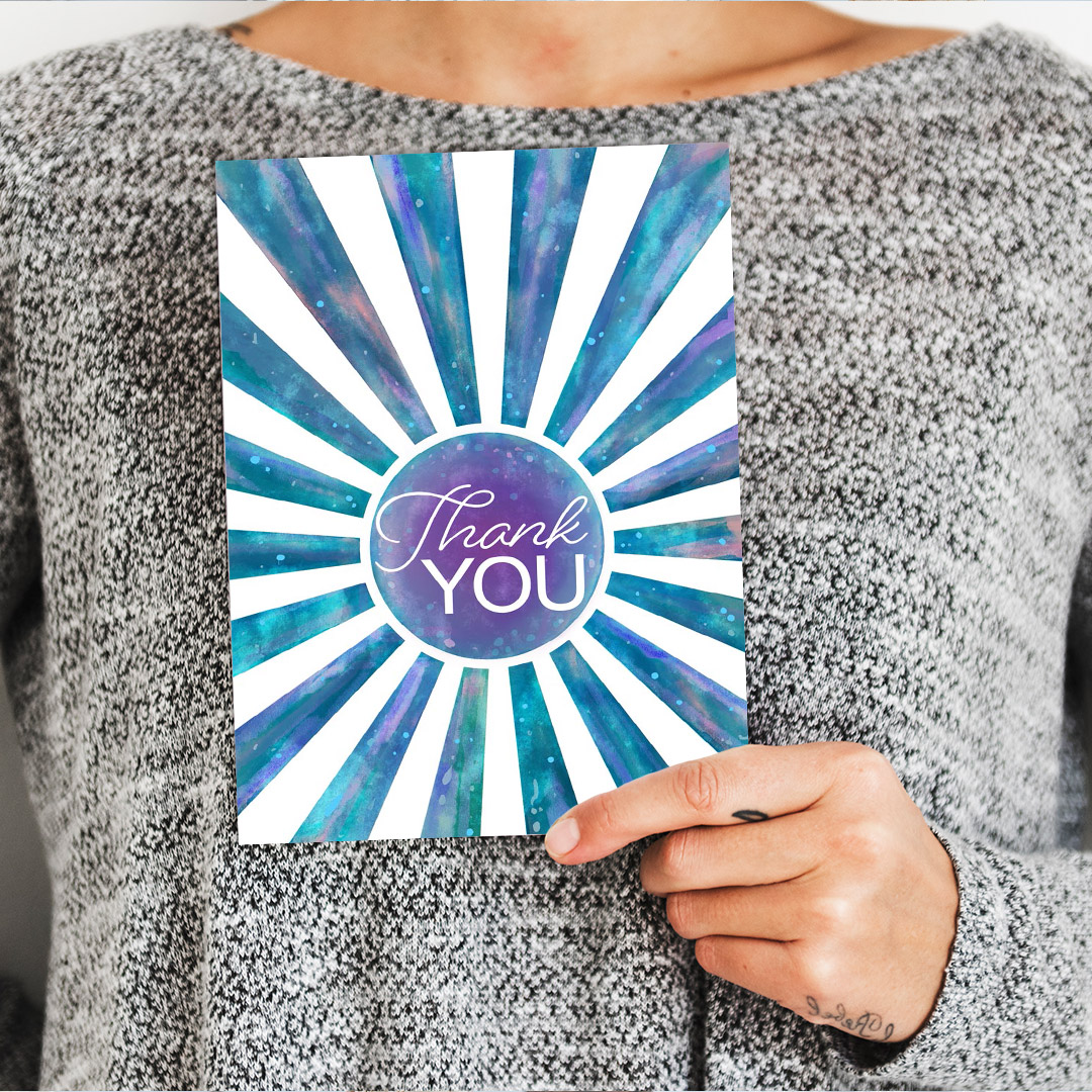 Woman holding a thank you card.