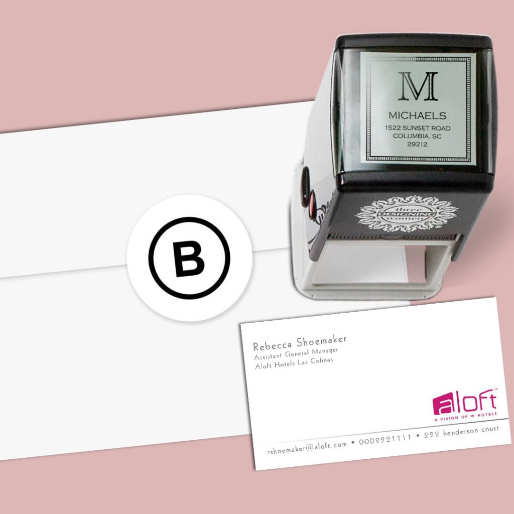Greeting card envelope, stamper, and an Aloft business card from CardsDirect on a pink background.